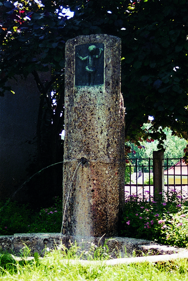 Das Foto zeigt den Carpe-Diem-Brunnen, welcher aus Stein ist.